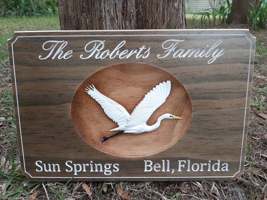 3d wood carved family last name sign with hand painted white heron. Coastal wall decoration, beach house wall art, coastal home decor. Made in the USA.